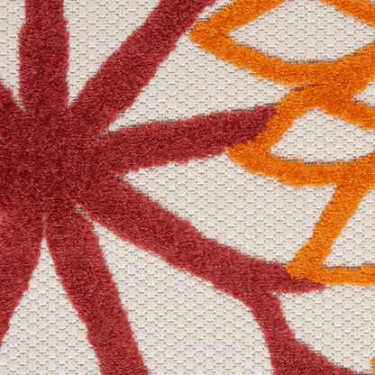 Beige loop-pile rug with a bold red starburst and orange circular motif, textured fibers; 3' x 5'.
