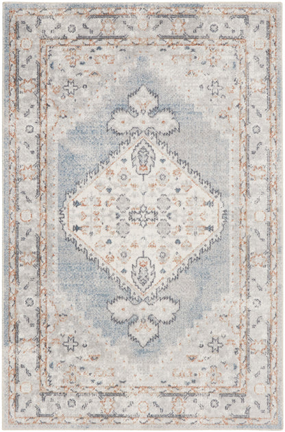 Blue and ivory distressed area rug with a central diamond medallion and ornate border.