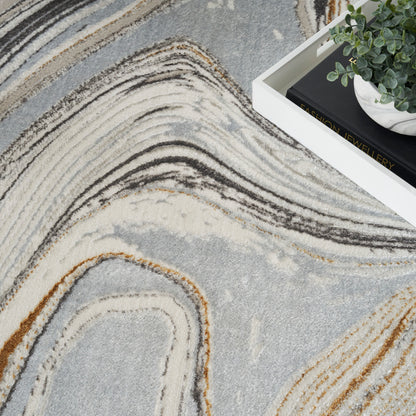 Abstract swirl-pattern area rug in grey, cream, taupe and tan; size 5' x 7'.