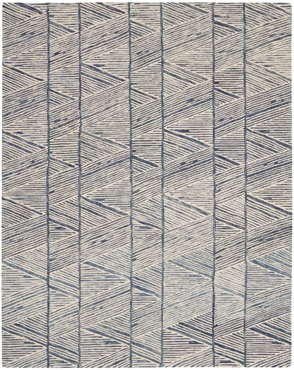 Beige woven rug with navy geometric chevron and diamond pattern.
