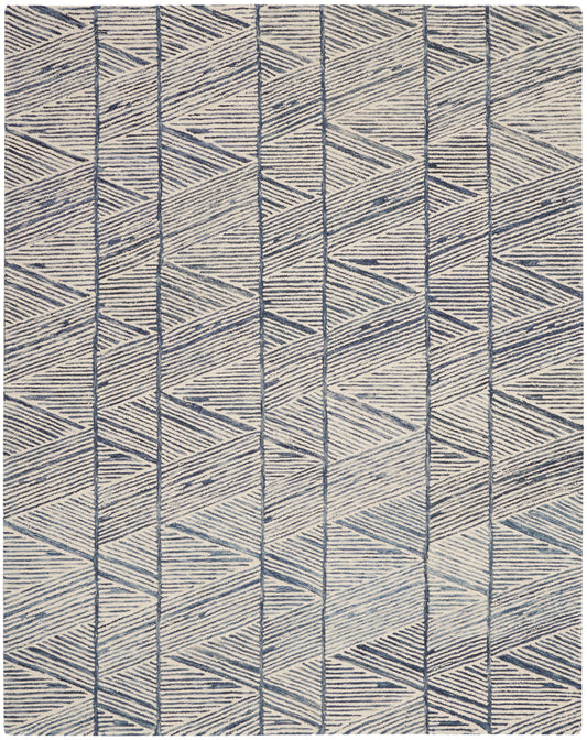 Beige woven rug with navy geometric chevron and diamond pattern.