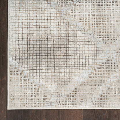 Rectangular beige/cream woven rug with abstract lattice pattern and distressed texture on dark wood floor