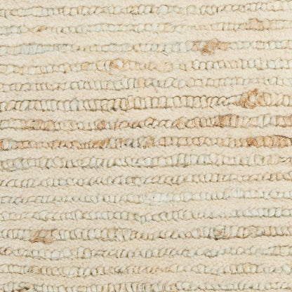 Beige looped shag rug close-up: soft twisted yarn and subtle brown specks.