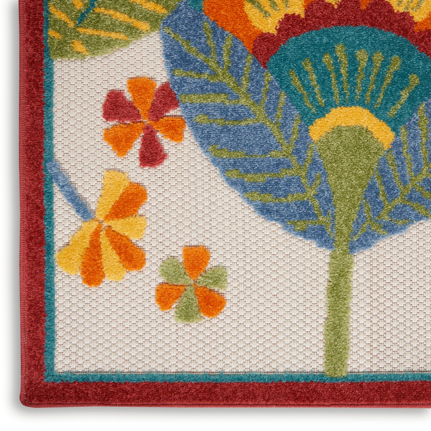 Woven textile with tropical leaf and flower motif; red border, teal trim, cream background, vibrant orange-yellow flowers.