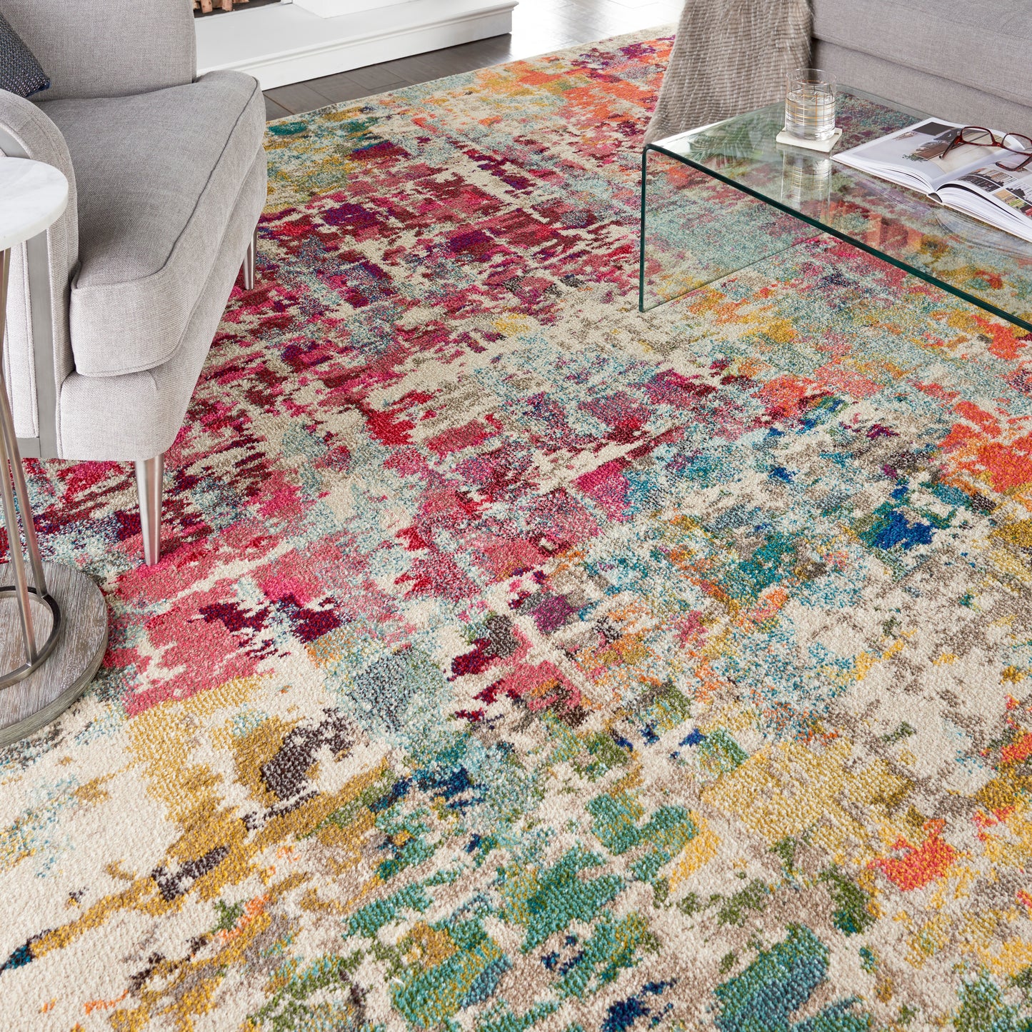 Abstract multicolor plush area rug with cream base; pink, teal, yellow & blue tones for modern living rooms.