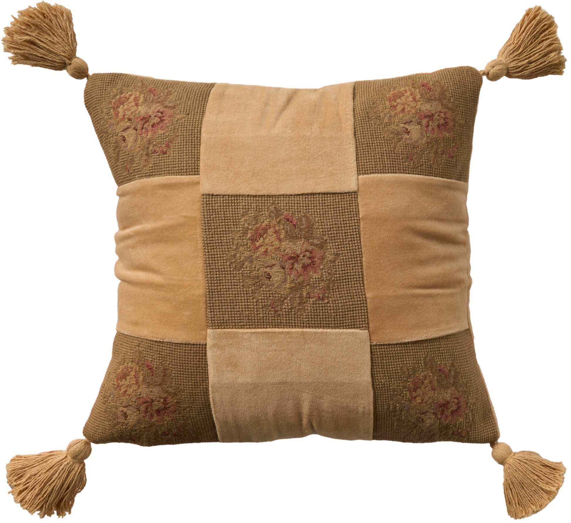 Square patchwork rug in tan and brown with floral patches and tassels at each corner.