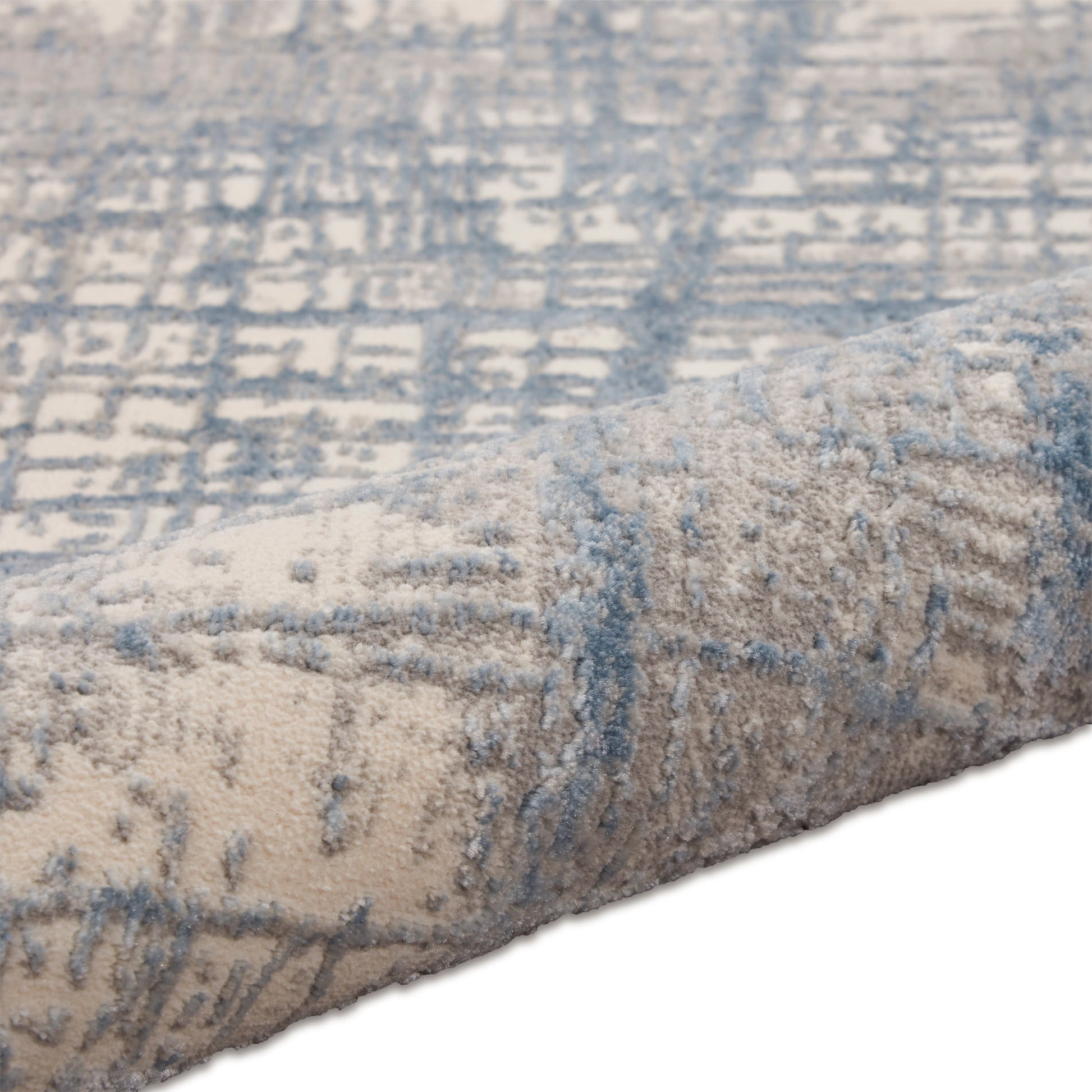 Plush beige area rug with a blue geometric pattern and soft pile, ideal for living room floors.