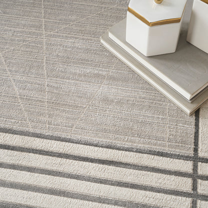 Neutral beige-gray rug with plaid and striped pattern; white ceramic jars with gold trim on a stack of books.