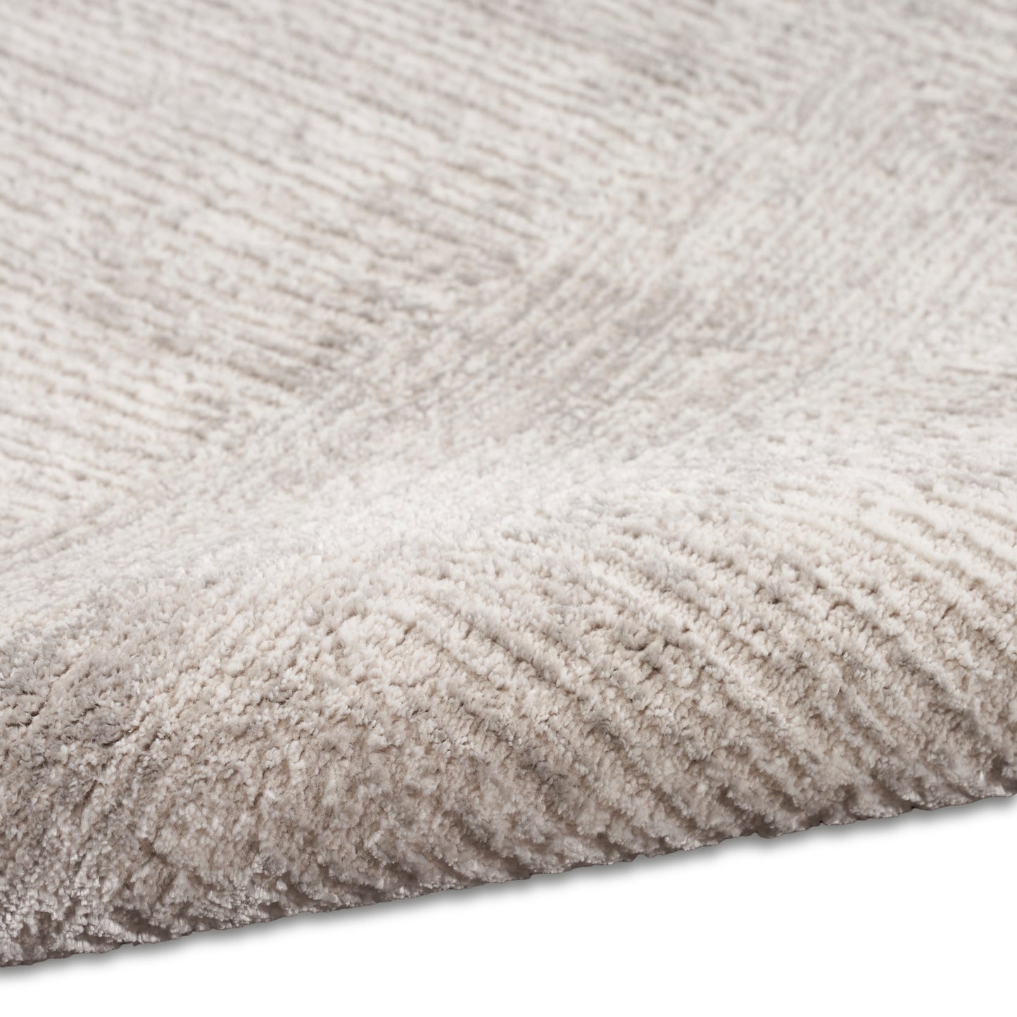 Beige plush shag rug close-up with soft high-pile fibers, cozy area rug.