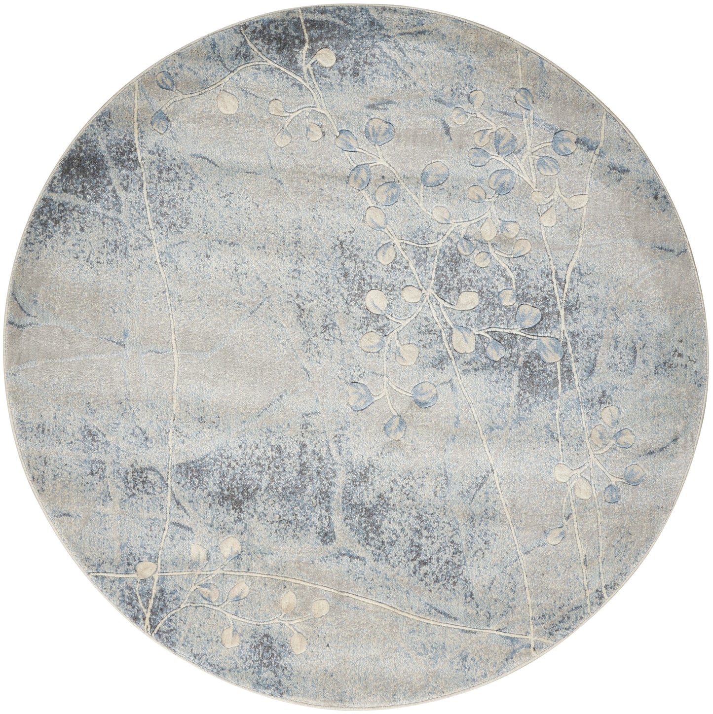 Round blue-gray rug with soft cloud-like texture and white botanical branch pattern.