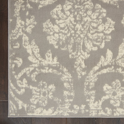 Rectangular gray rug with ivory damask floral pattern; traditional living room accent.
