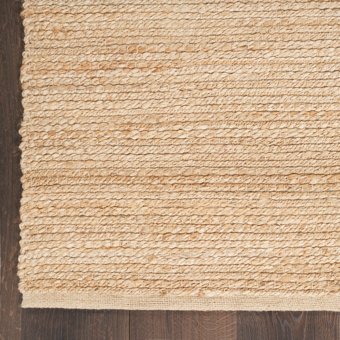 Beige gradient rug bordered by natural jute rope on dark wood floor, rectangular farmhouse style.