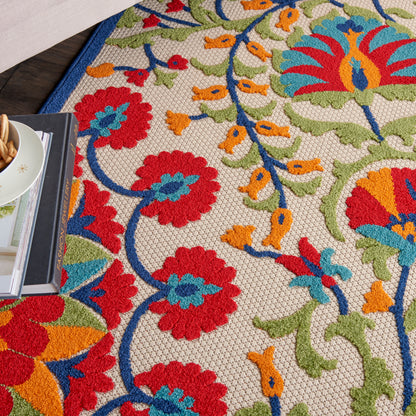 Colorful floral tapestry fabric with red, blue, orange flowers and green vines on a beige background
