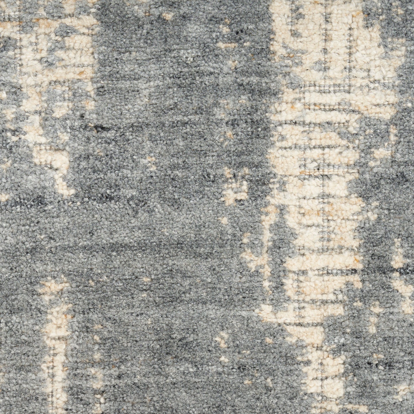Distressed abstract area rug in blue-gray and ivory tones with a soft, woven pile.