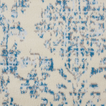 Cream rug with blue abstract floral/damask pattern; woven.