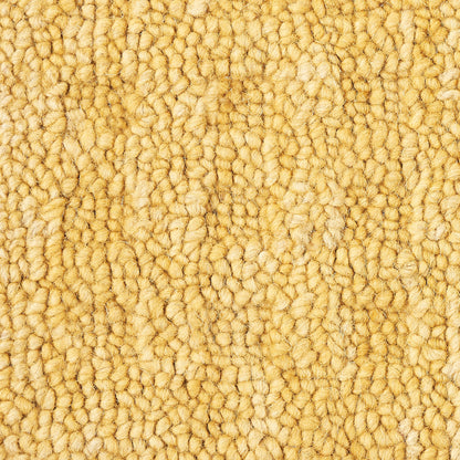 Warm beige textured looped-pile carpet close-up with dense plush fibers.