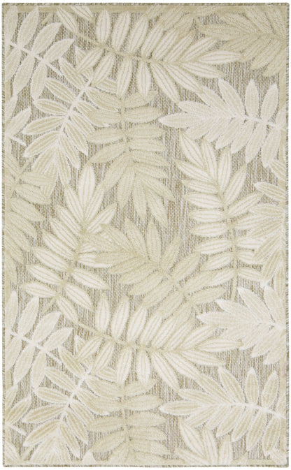 Beige and ivory woven rug with palm leaf pattern; neutral tropical design, rectangular area rug for living spaces.