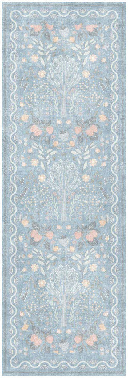 Light blue lace-style rug runner with white floral motifs and pale peach accents, scalloped border.