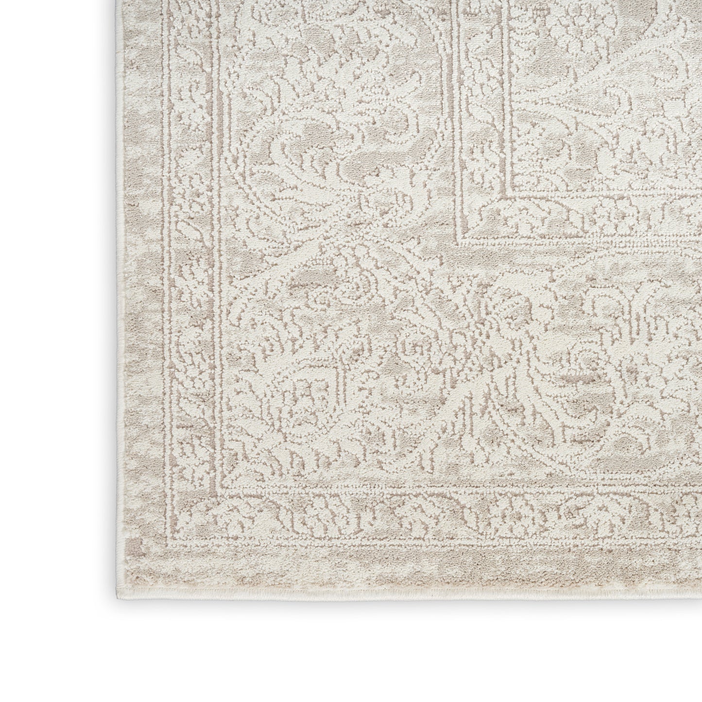 Beige oriental rug with intricate floral border and soft, textured pile in ivory and taupe tones.
