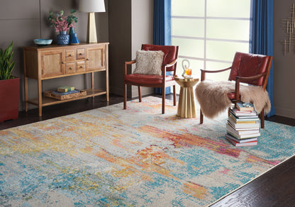 Large abstract multicolor rug in blues and yellows; red leather chairs with fur throws, wooden console, gold side table.