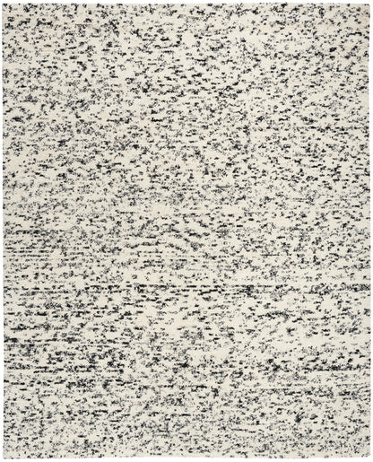 Rectangular beige speckled area rug with charcoal flecks; flat-weave, modern neutral rug.