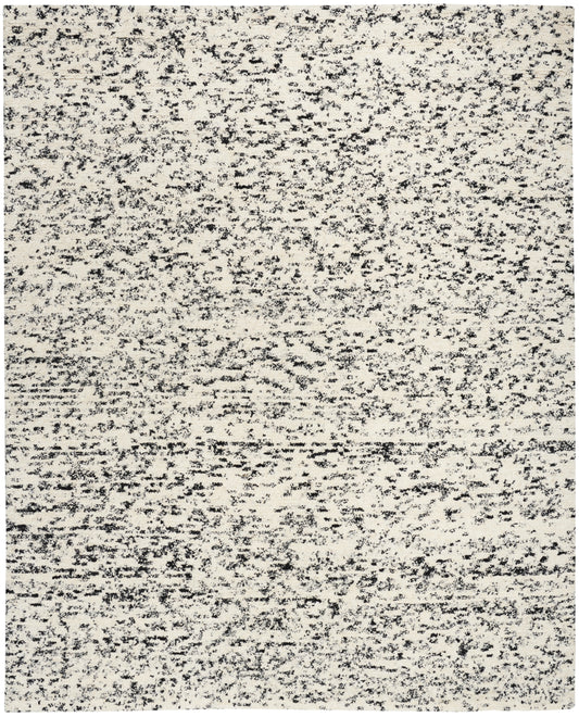 Rectangular beige speckled area rug with charcoal flecks; flat-weave, modern neutral rug.