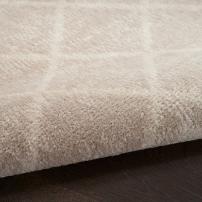 Beige plush Bohemian runner rug with a subtle plaid pattern and soft pile on dark wood floor.