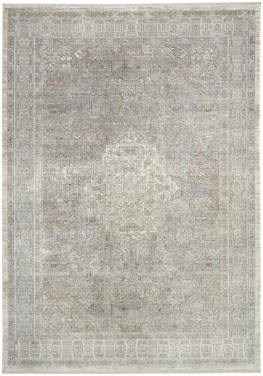 Distressed antique-style oriental area rug in muted blue, gray & ivory tones with a central medallion and ornate border.
