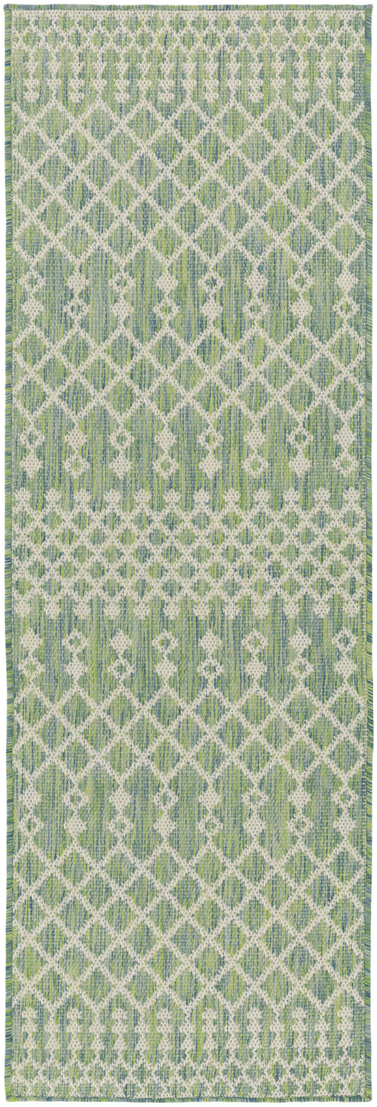 Green and white geometric woven runner rug with a diamond lattice pattern and fringe ends.