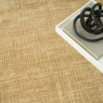 Beige patterned carpet with a white tray holding black circular metal rings as decorative accents.