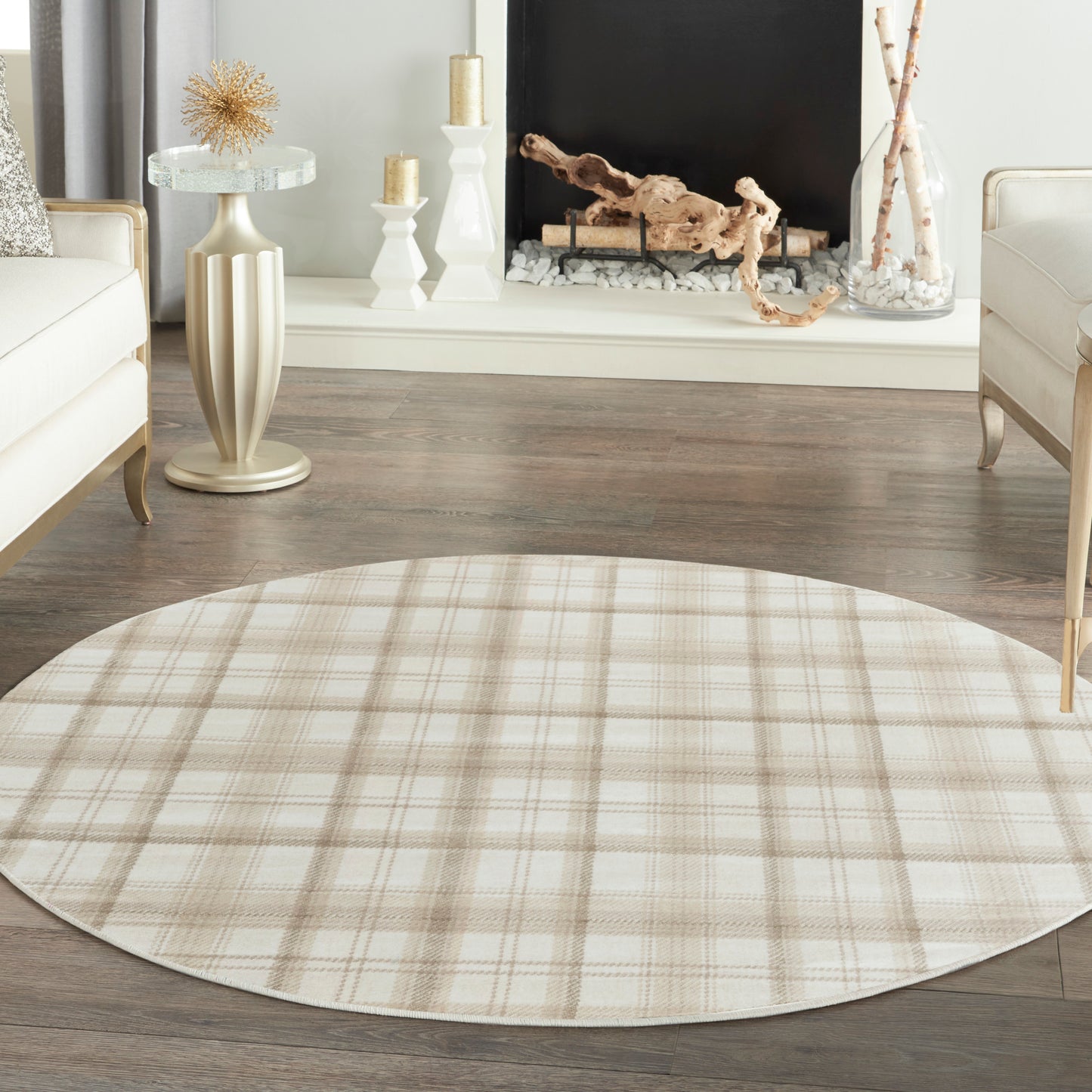 Beige plaid round area rug on dark wood floor in a cream-toned living room.