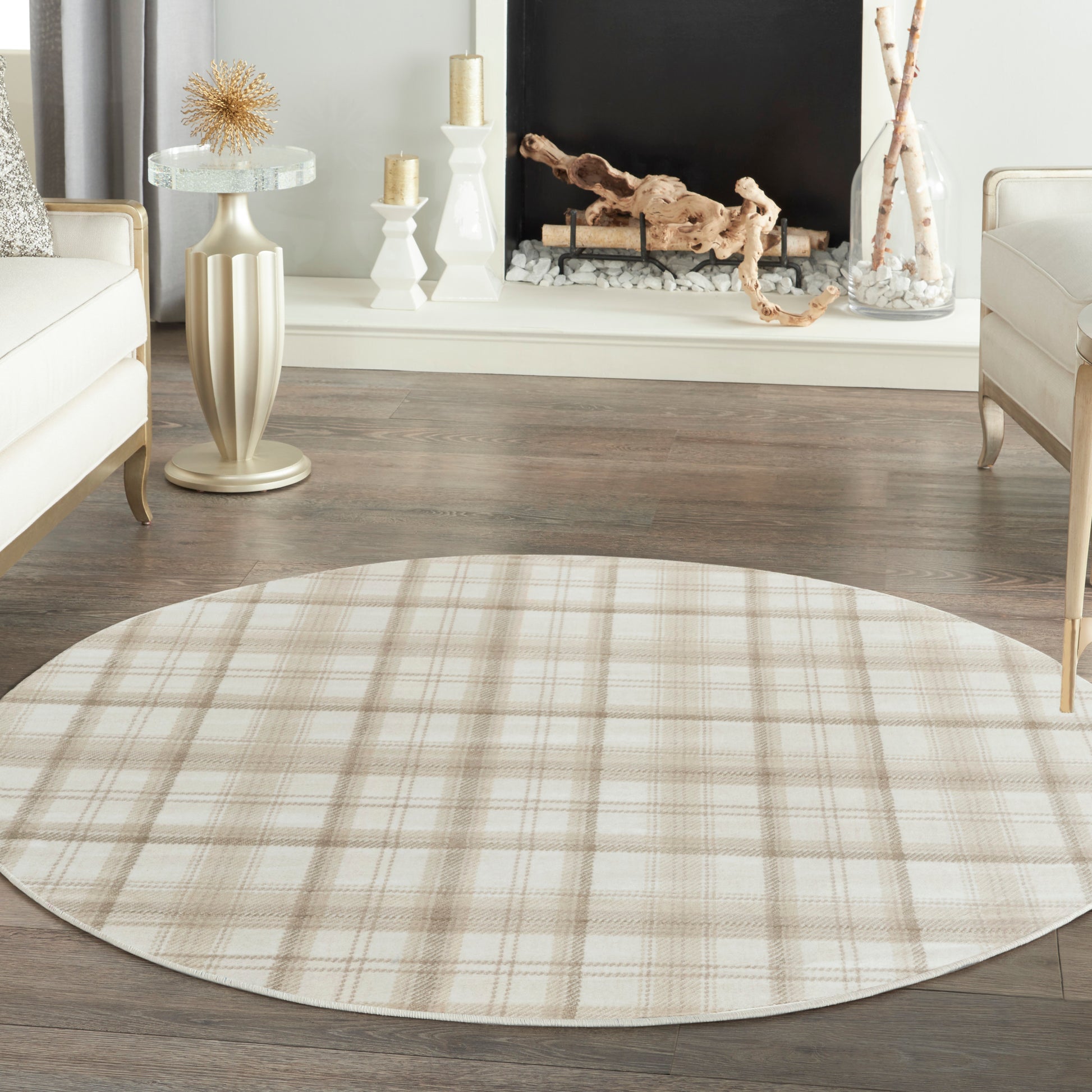 Beige plaid round area rug on dark wood floor in a cream-toned living room.