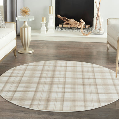 Beige plaid round area rug on dark wood floor in a cream-toned living room.