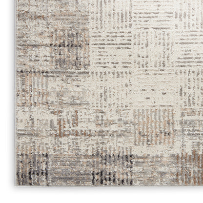 Neutral patchwork runner rug with beige, taupe, gray and brown blocks in a distressed woven pattern.