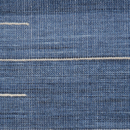 Close-up of blue denim fabric with white weft threads and light horizontal seam lines.