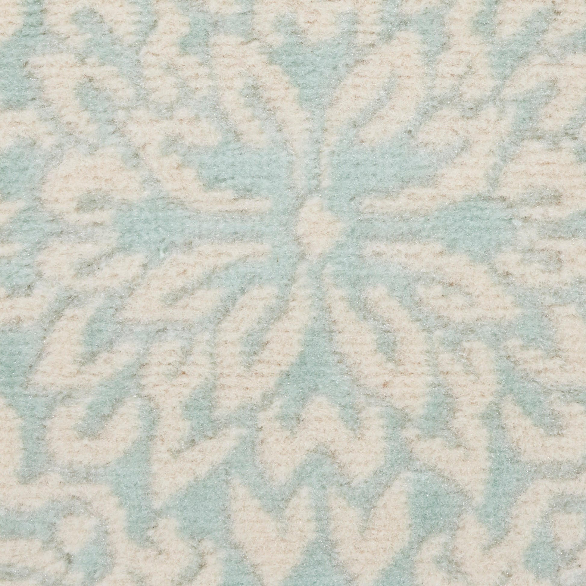 Soft light-blue and ivory tufted rug featuring a large snowflake/starburst motif.