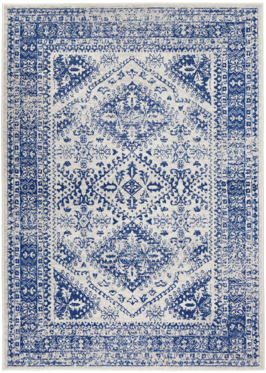 Blue & white distressed oriental rug with central medallion and ornate border; rectangular area rug.