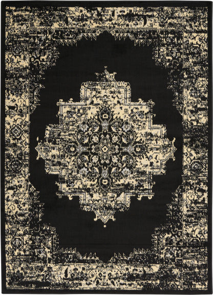 Black oriental rug with a cream distressed central medallion and ornate border; vintage Persian-inspired floor decor.