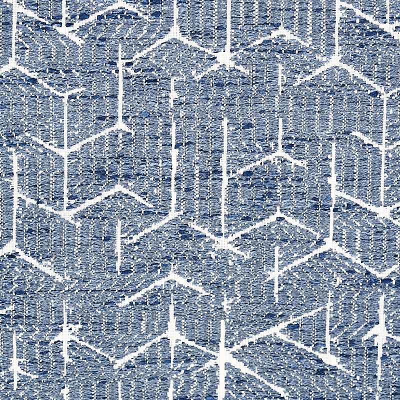 Blue and white geometric chevron rug with textured woven fabric and zigzag pattern.