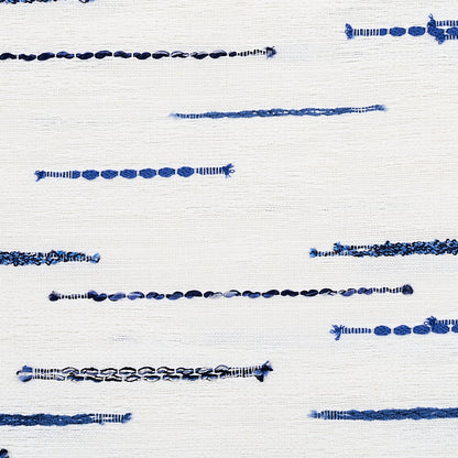 White fabric with scattered horizontal blue stitching lines, denim-inspired embroidery for decorative detail.