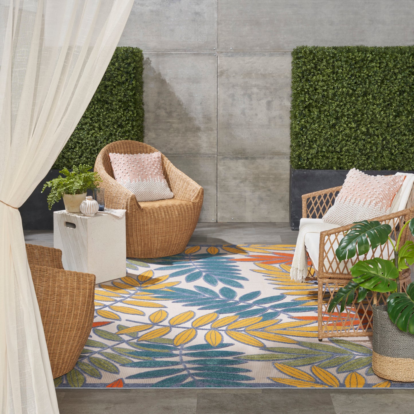 Outdoor tropical leaf rug in blue and yellow, 7' x 10'.