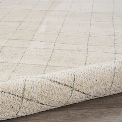 Beige 8' runner rug with a subtle dark grid pattern and soft pile, curled edge on wood floor.