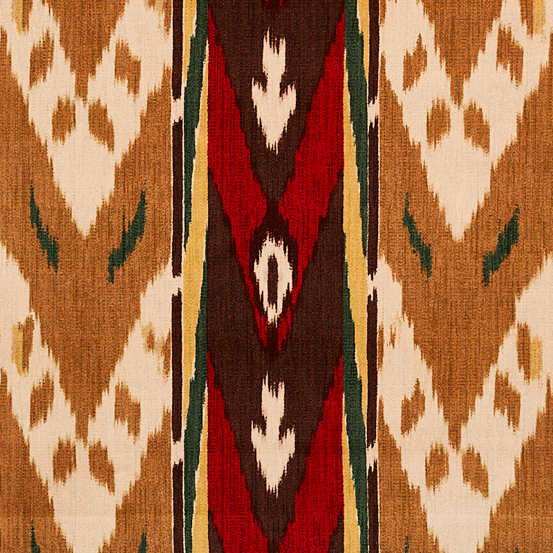 Woven kilim rug with tan base and white diamond motifs, central red-brown geometric stripe edged by green borders.