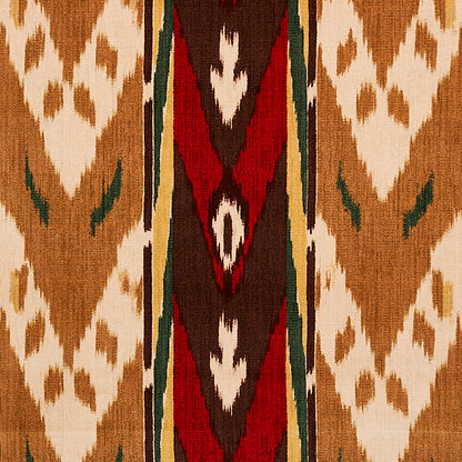 Woven kilim rug with tan base and white diamond motifs, central red-brown geometric stripe edged by green borders.