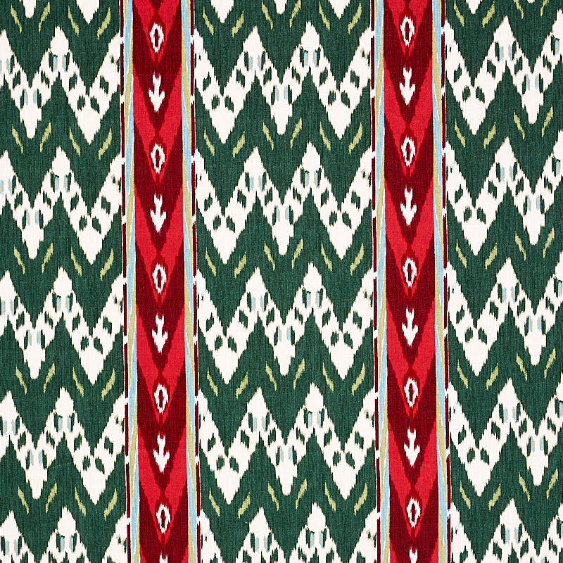Woven textile with green and white zigzag diamond pattern and two bold red vertical stripes.
