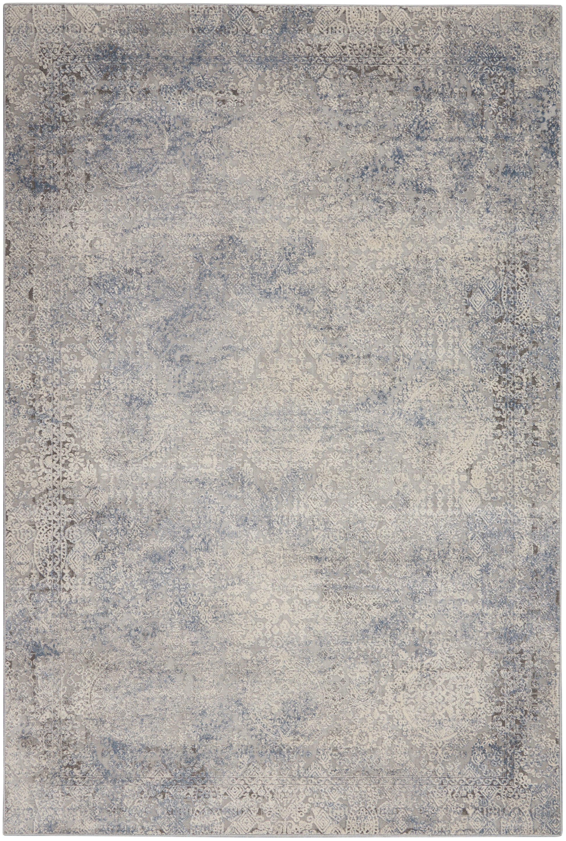 Distressed blue-gray oriental rug with ivory floral medallion patterns and antique vibe