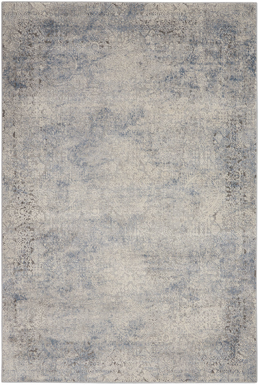 Distressed blue-gray oriental rug with ivory floral medallion patterns and antique vibe