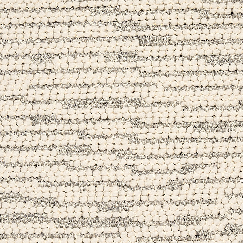 Cream pom-pom beads arranged in horizontal stripes on gray textured woven fabric; boucle-style textile for throws or cushions