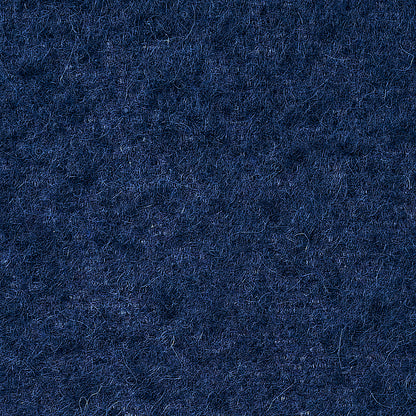 Close-up of navy blue wool felt texture with fuzzy fibers.