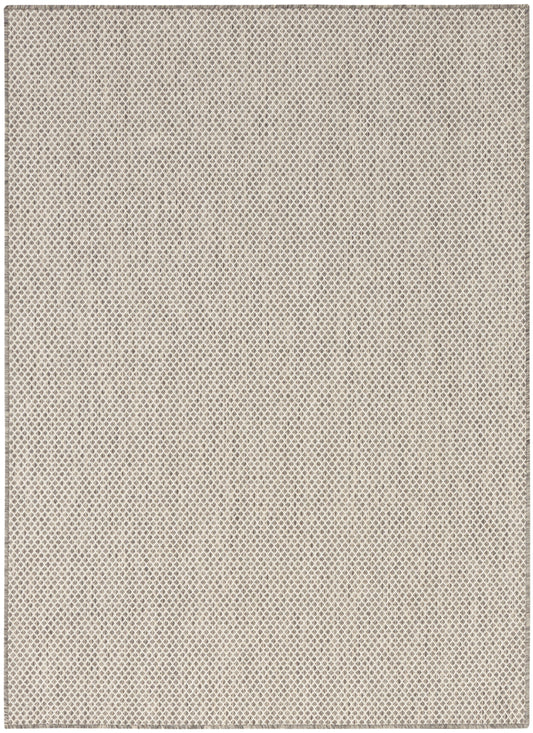 Beige woven rug with subtle diamond lattice texture; neutral flat-weave style.